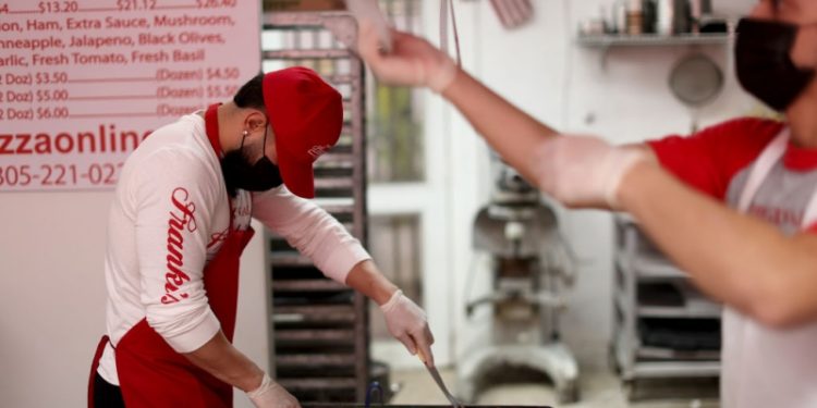 一位Frankie's Pizza員工正在切割食物。（Getty Images）