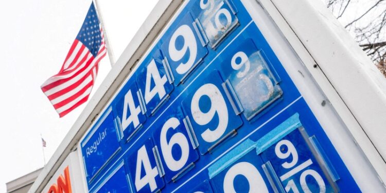 FILE PHOTO: A small sticker featuring U.S. President Donald Trump and Elon Musk, in lower right of sign, at a gas station on Capitol Hill in Washington, D.C., U.S., March 8, 2026. REUTERS/Nathan Howard/File Photo